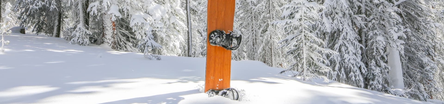 Snowboard in the snowy ground of mountain from Virgin Islands Ski Rental