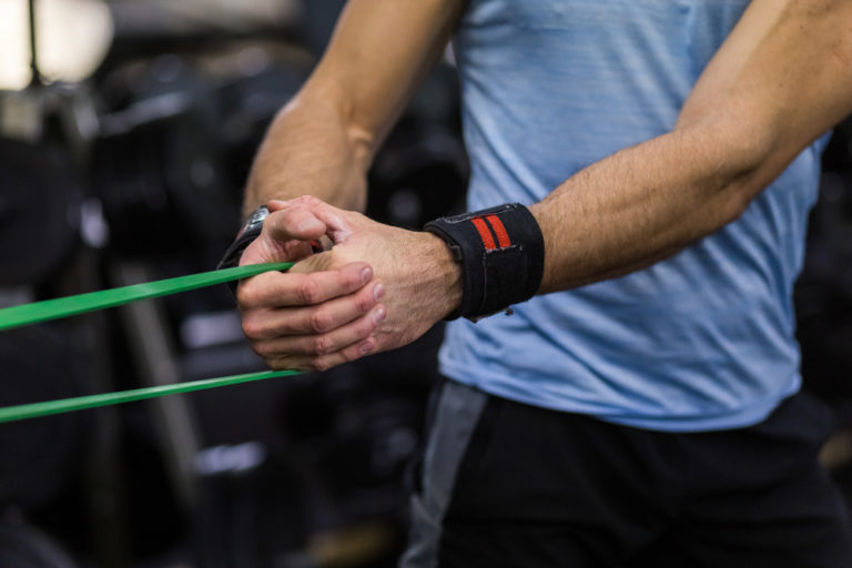 Close up shot of someone using exercise band to workout.