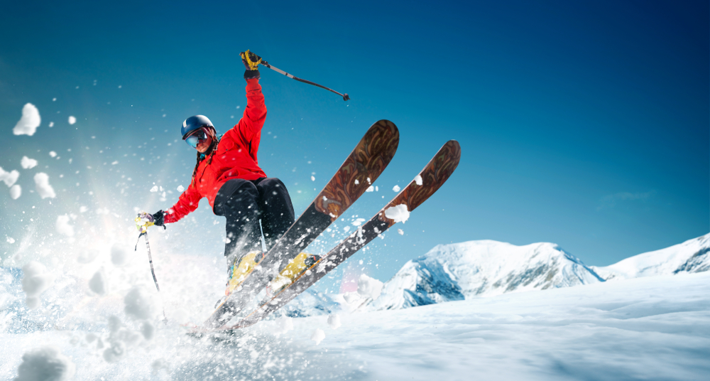 Skier enjoying a sunny day on a snow-covered slope.