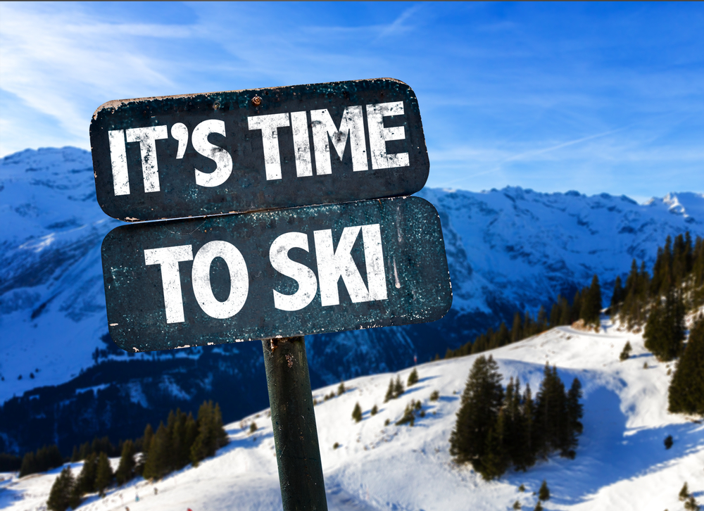 Snowy mountain ski sign promoting the skiing season.