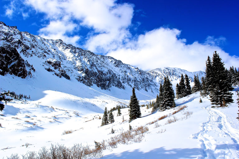 A sunny day featuring snowy mountains for skiing. Virgin Island Ski Rental offers ski rentals.
