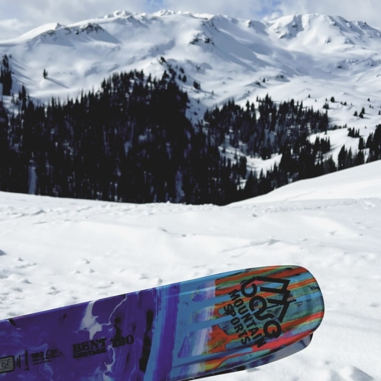 Base Mountain Sports branded ski with snowy Colorado mountain in background